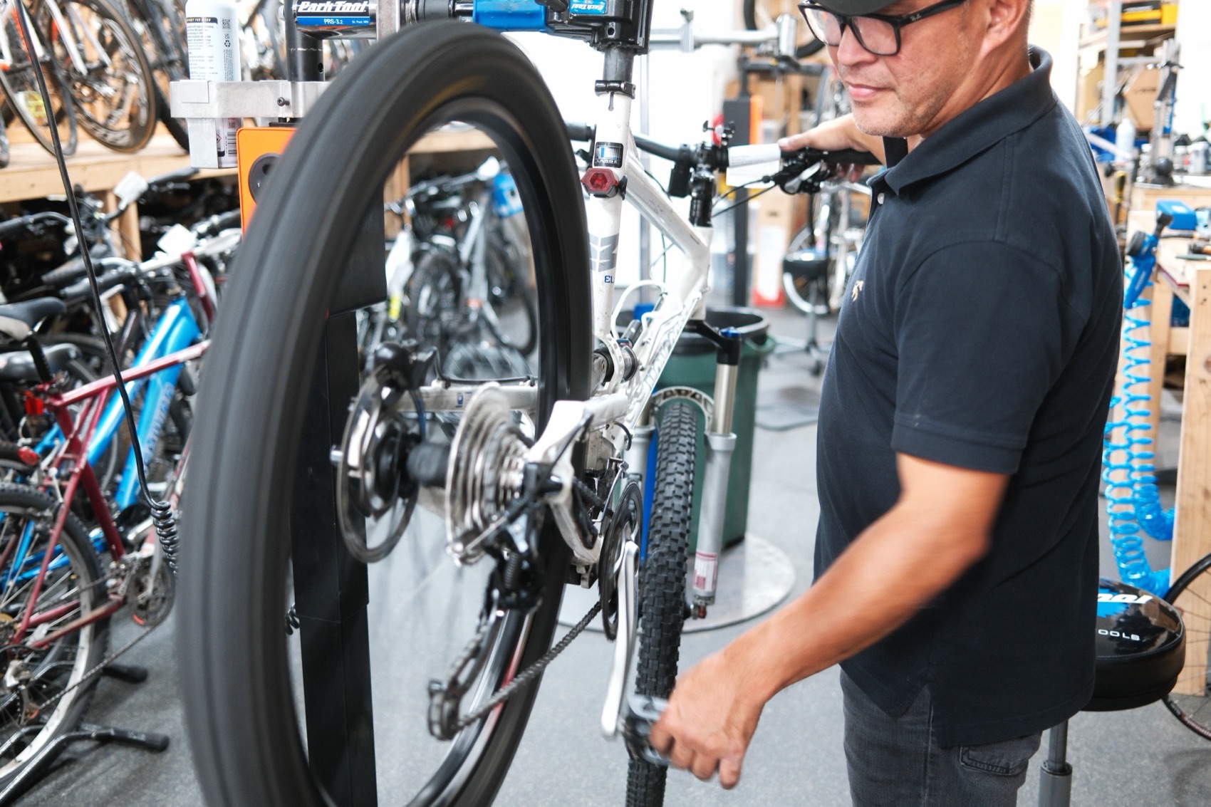 Mechanic working on a bike wheel, close up