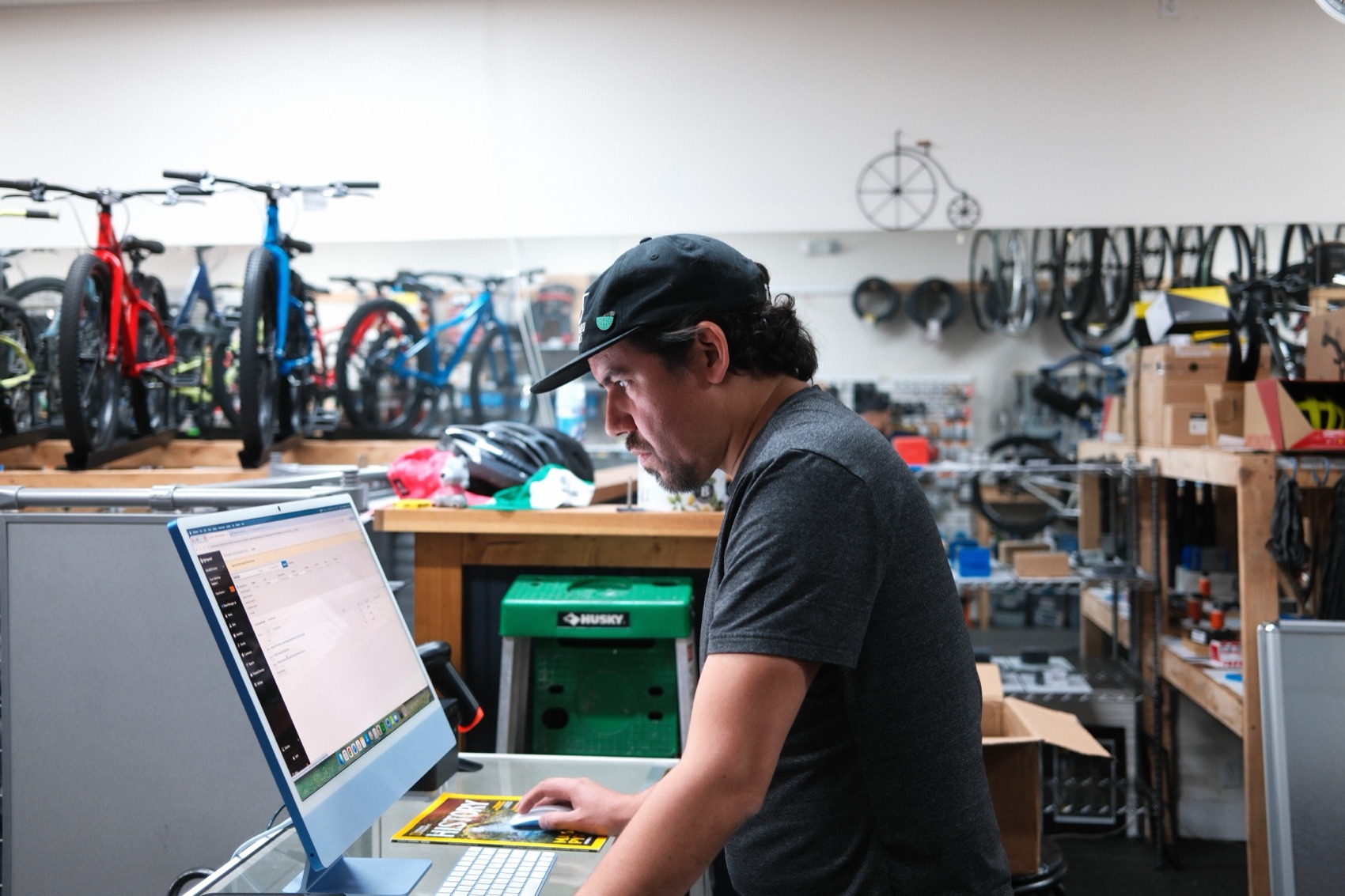 Staff member at the shop's point-of-sale desk