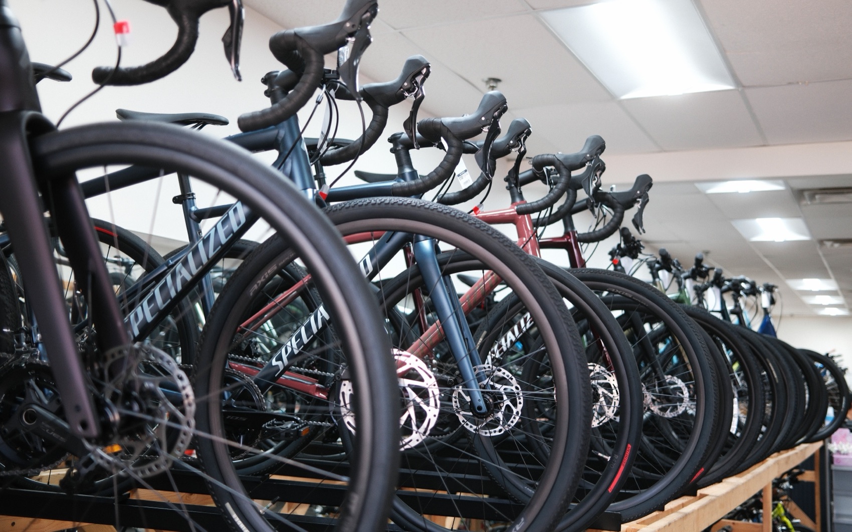 Row of Specialized road bikes receding down the showroom at Oscar's Bike Shop